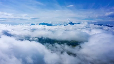 Aerial hyperlapse flight over the clouds in the mountains Stock Footage