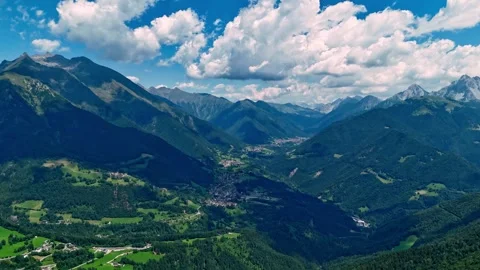 Aerial hyperlapse footage of moving clouds over lush green mountain peaks and Stock Footage 342575735