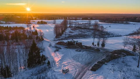 Aerial Hyperlapse of a Forestry Crane Loading Timber Logs in Winter Snow Stock Footage 333321428
