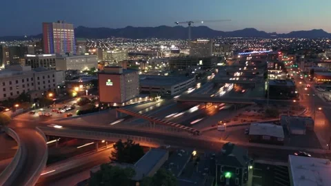 Aerial Hyperlapse of freeway traffic and El Paso City skyline at sunset, Video stock 163809937