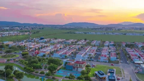 Aerial hyperlapse, houses in the country side and sunset Stock Footage