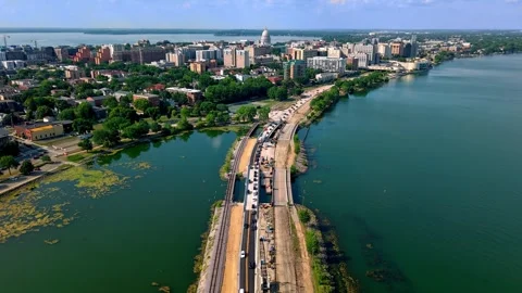 Aerial hyperlapse of a lake causeway construction and Madison Wisconsin skyline Stock Footage 340550745