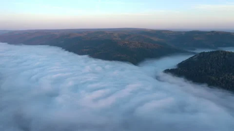 Aerial hyperlapse of mist flow in a mountain gorge at dawn Video stock 149361232