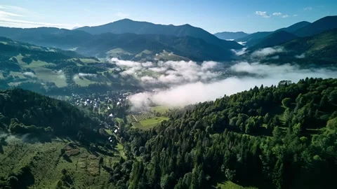 Aerial hyperlapse of a misty mountain valley with a small village Video stock 317629682
