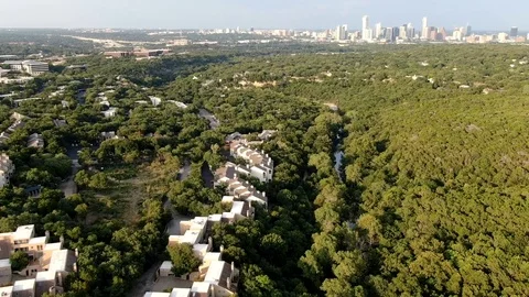 Aerial Hyperlapse over Barton Creek with Austin City Skyline - Austin, TX Stock Footage 113971503