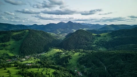 Aerial Hyperlapse over Green Mountain Valley with Forested Hills and Cloudy Sky Video stock 313873074