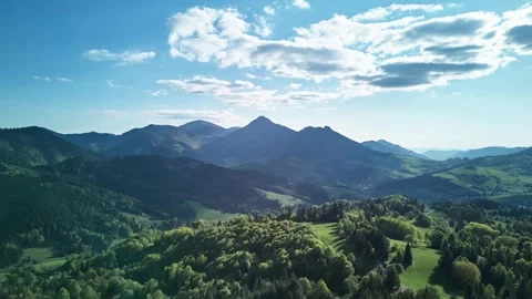 Aerial Hyperlapse over Green Mountains and Forests on a Sunny Spring Day Stock-Footage 313884513