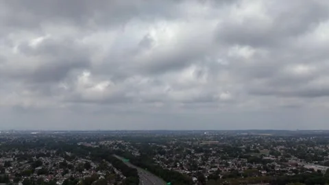 An aerial hyperlapse over a highway on Long Island, New York on a cloudy 動画素材 250146448