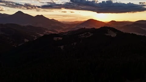 Aerial hyperlapse over hilly forested landscape with dramatic clouds at twilight Stock-Footage 308109570