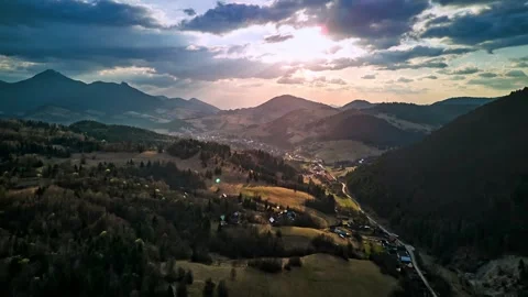 Aerial hyperlapse over hilly rural landscape with dramatic clouds at twilight Stock-Footage 308394557