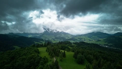 Aerial Hyperlapse over Lush Mountain Landscape with Clouds and Mist after Rain Stock Footage 313871967