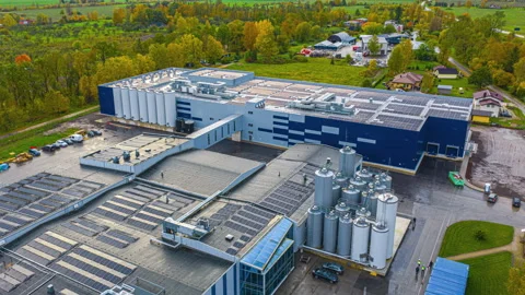 Aerial hyperlapse over modern dairy processing plant Baltic Dairy Board in Stock Footage 331833882