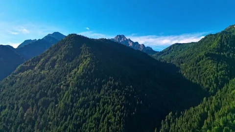 Aerial hyperlapse over rugged green mountain ridges and deep valleys in Val di Stock Footage 342576129