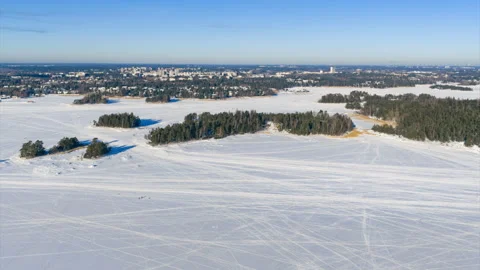 Aerial hyperlapse of people walking on ice in the frozen archipelago of Finland Stock Footage 331195309