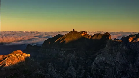Aerial hyperlapse shot of a sunlit mountain peak at sunrise , Madeira Stock Footage 301382701