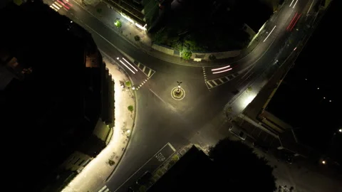 Aerial hyperlapse of a small roundabout at night with traffic Stock Footage 249596136