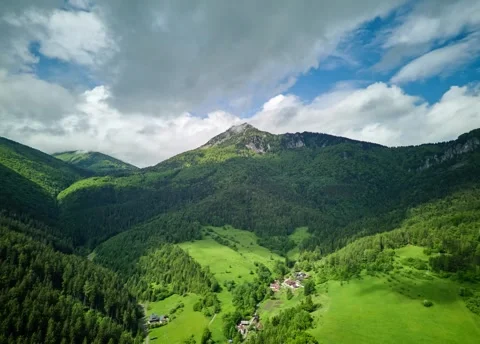 Aerial Hyperlapse spring Mountains,fluffy clouds,green meadows Stock Footage 297466876