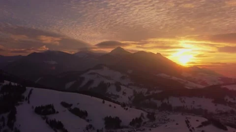 Aerial hyperlapse of sunset, Orange clouds , winter rural landscape in mountains Stock Footage 233632292