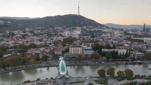 Aerial hyperlapse of Tbilisi central park and Bridge of Peace at sunset Stock-Footage 289730572
