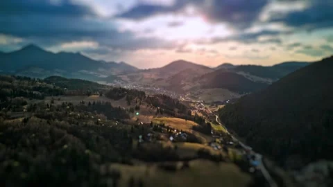 Aerial hyperlapse with tilt-shift effect over hilly rural landscape and Stock-Footage 306014302