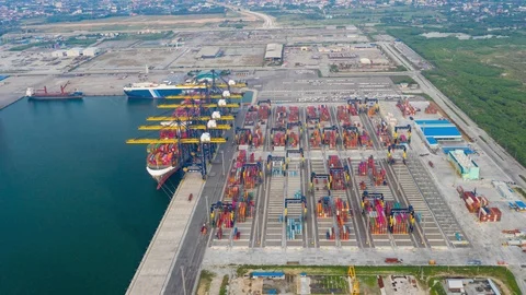 Aerial Hyperlapse Time lapse. Container ships in the harbor with bridges Crane Stock Footage 117042953