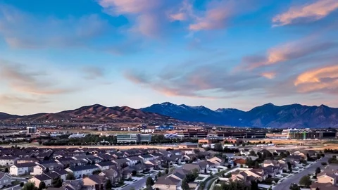 Aerial hyperlapse of a town below the mountains Stock Footage 112674452