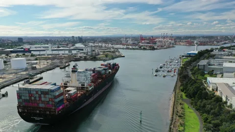 Aerial hyperlapse video of cargo ship arriving at Melbourne with view of CBD Stock Footage 154346026