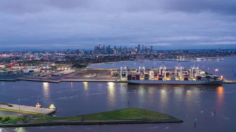 Aerial hyperlapse video of cargo terminal and Melbourne CBD at night Stock Footage 165379220