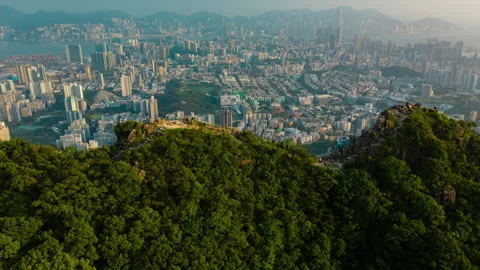 Aerial hyperlapse video of flying over Lion Rock revealing Hong Kong city Stock Footage 250391784