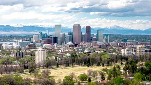 Aerial hyperlapse view over expansive lawns of Cheesman Park toward Denver city Stock Footage 334515358