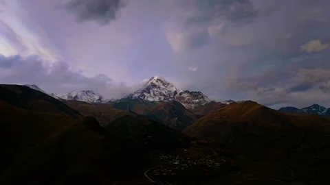 Aerial hyperlapse view of snow-covered Mount Kazbegi Stock Footage 320253912