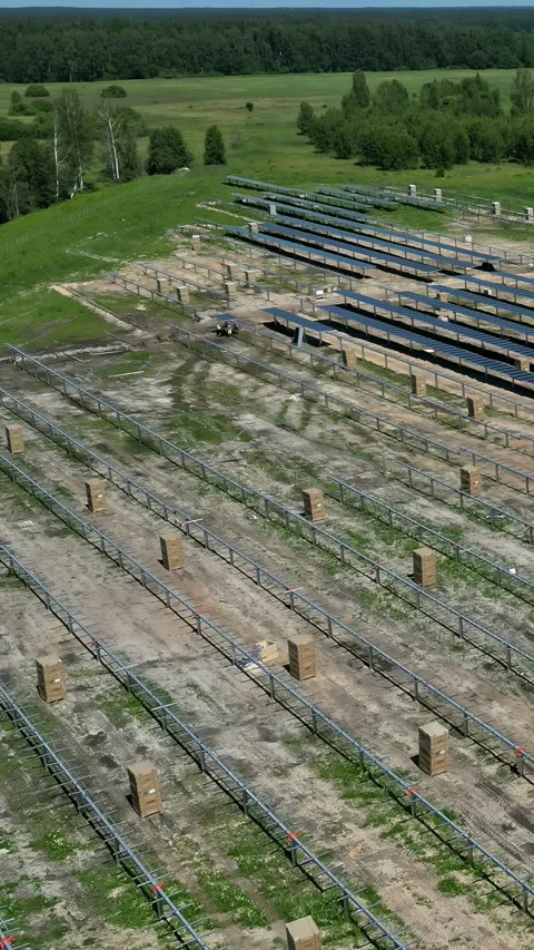 Aerial hyperlapse view of solar panels in construction with green fields and Stock Footage 304037923