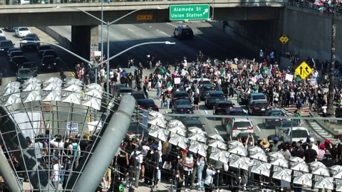 AERIAL: ICE protesters conquering the streets of Los Angeles, USA, sunny day Stock Footage 312105493