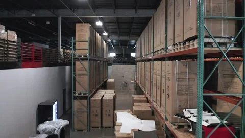 Aerial, identical cardboard boxes on pallets racks in shipping storage Stock Footage 240805027