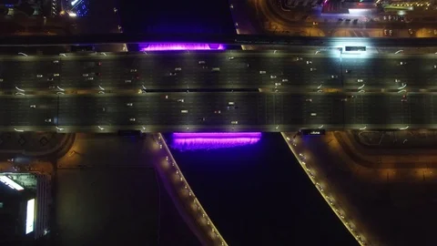 Aerial. Illuminated Waterfall at the Sheikh Zayed Bridge. Dubai Water Canal. 4K Stock Footage 80199899