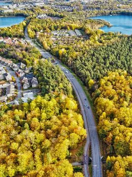Aerial image of the road between two lakes and autumn tries Stock Photos