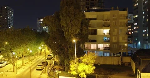 Aerial image of a small building at night in a cosy neighborhood Vídeo Stock 68288091