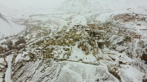 Aerial imagery of Lamayuru Monastery amidst a snowy landscape. Stock Footage 310661069