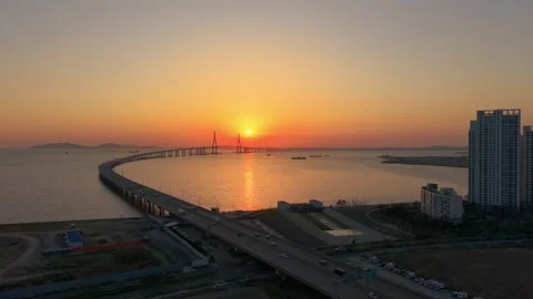 Aerial Incheon Bridge and expressway traffic during golden sunset Stock Footage 340200064