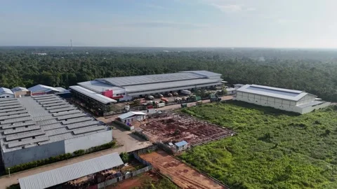 Aerial Industrial Complex Surrounded by Lush Forest Stock Footage 333295756