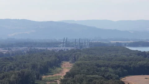 Aerial of industrial view over forest and mountains near Portland Oregon Stock Footage 339301889
