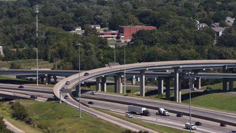Aerial of interstate 470 interchange over forested suburban area in Kansas City Stock Footage 344810580