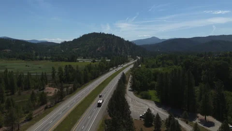 Aerial of Interstate 90 through forested valley near Cataldo Idaho Video stock 337369893