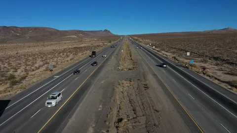 Aerial interstate freeway traffic Nevada California border fast pull 4K 207 Stock Footage 99716408