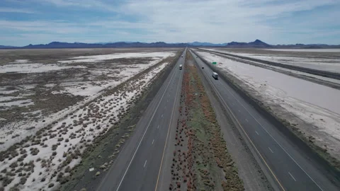 Aerial of an interstate highway running through a barren desert Stock Footage 237814513