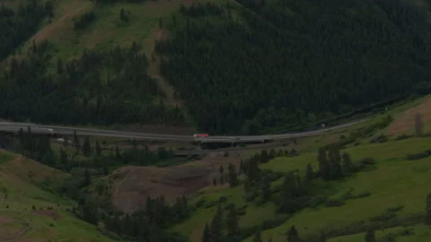 Aerial of interstate through La Grande Oregon in spring in grassy mountains Stock Footage 335838901