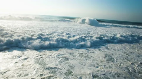 Aerial of jet ski driver getting over big ocean waves during sunny day Stock Footage 156613252