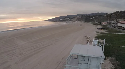 Aerial jib down to sand back up again over Lifeguard tower at sunset #12 Stock Footage 46628520