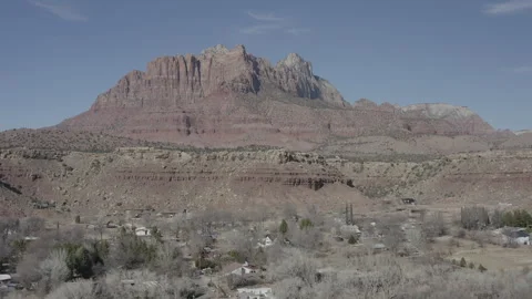 Aerial jibs up looking at the colorful mountains of Zion National Park in Utah Stock-Footage 303388341