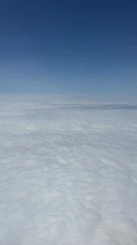 Aerial journey: expansive cloudscape transitions under clear blue sky Video stock 320851387